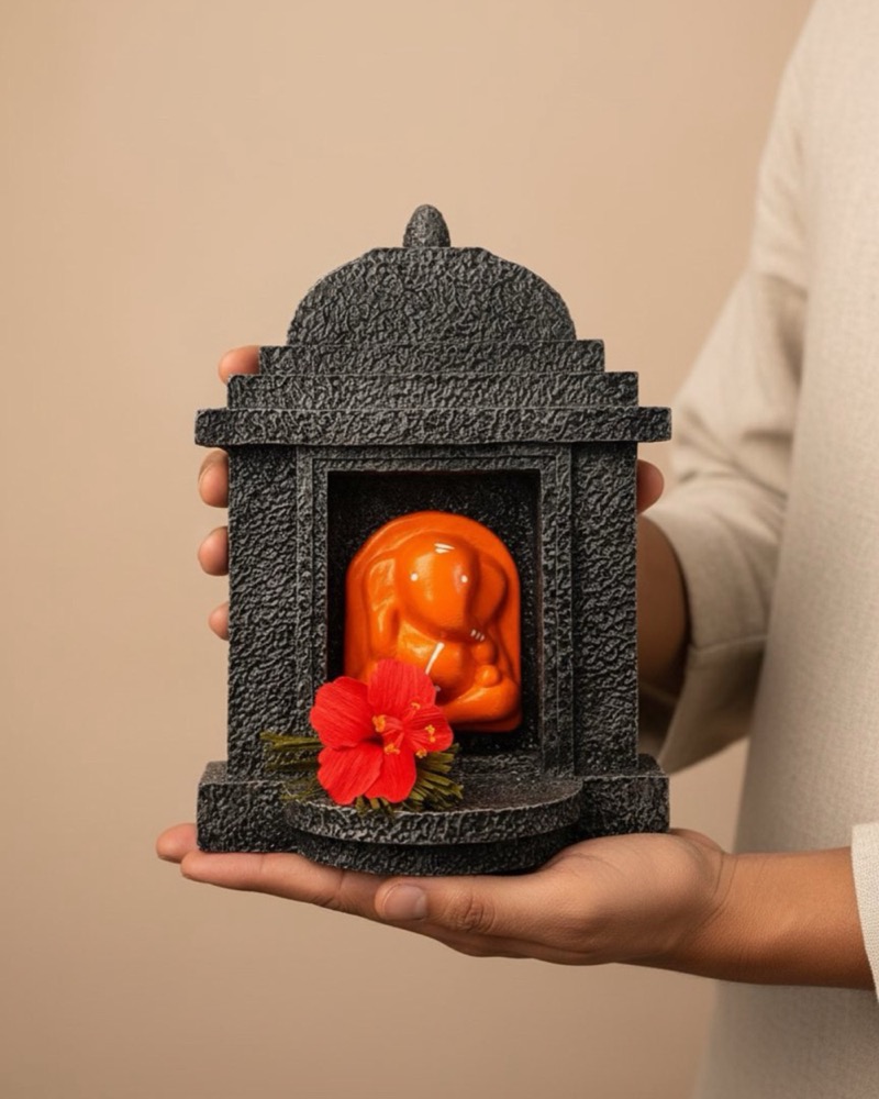 The temple held in one open hand, showing its seven inch scale.