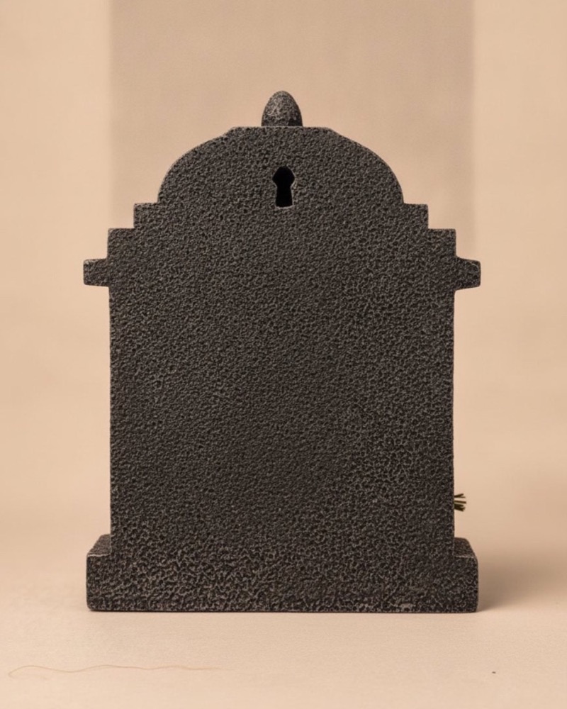 The flat back of the temple with its recessed keyhole hanging slot.