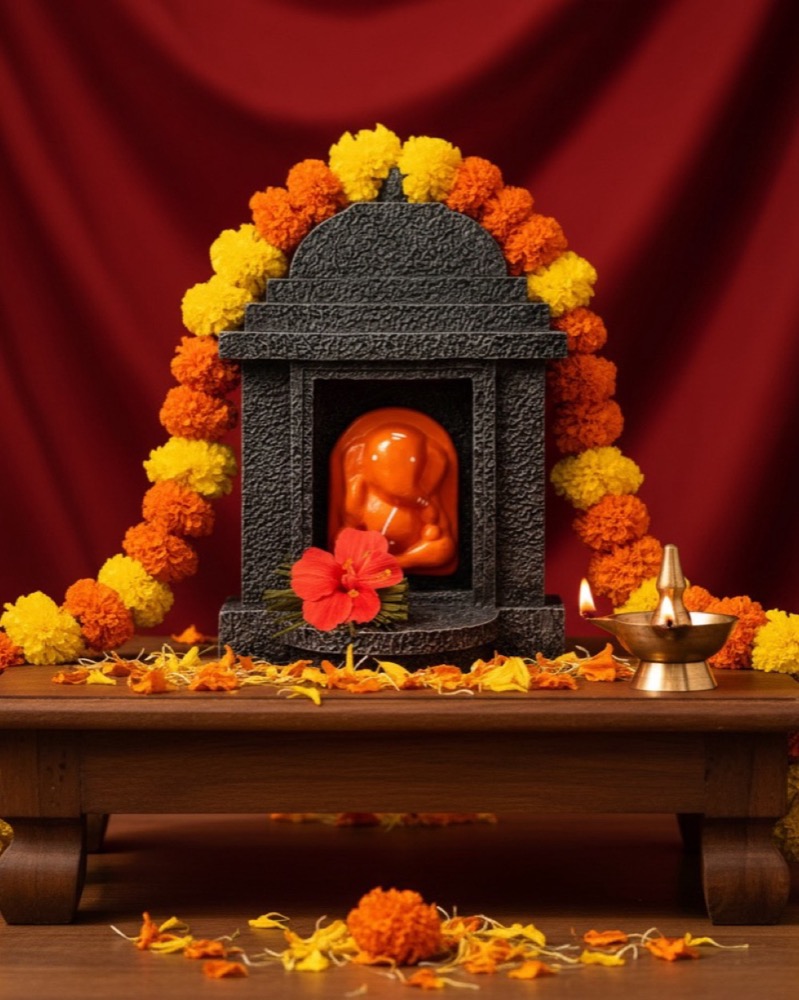With a marigold garland.