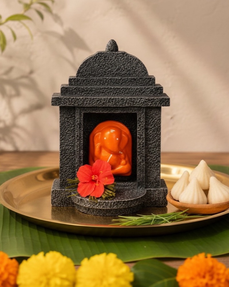 Modak, durva and a brass thali.